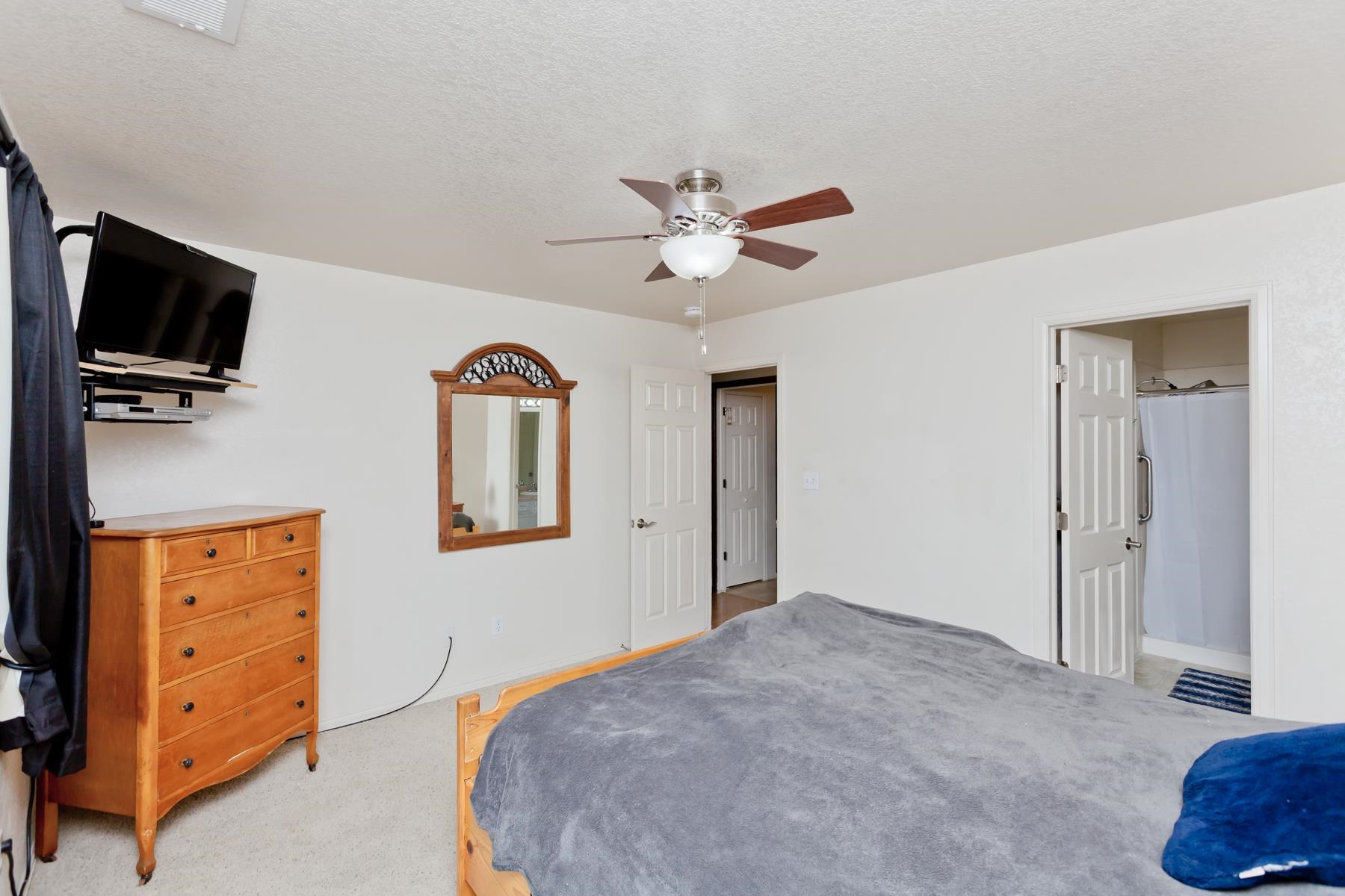 231 Narrow Leaf Drive Fruita, CO 81521 - Photo 24 of 40 a bedroom with a bed and a television
