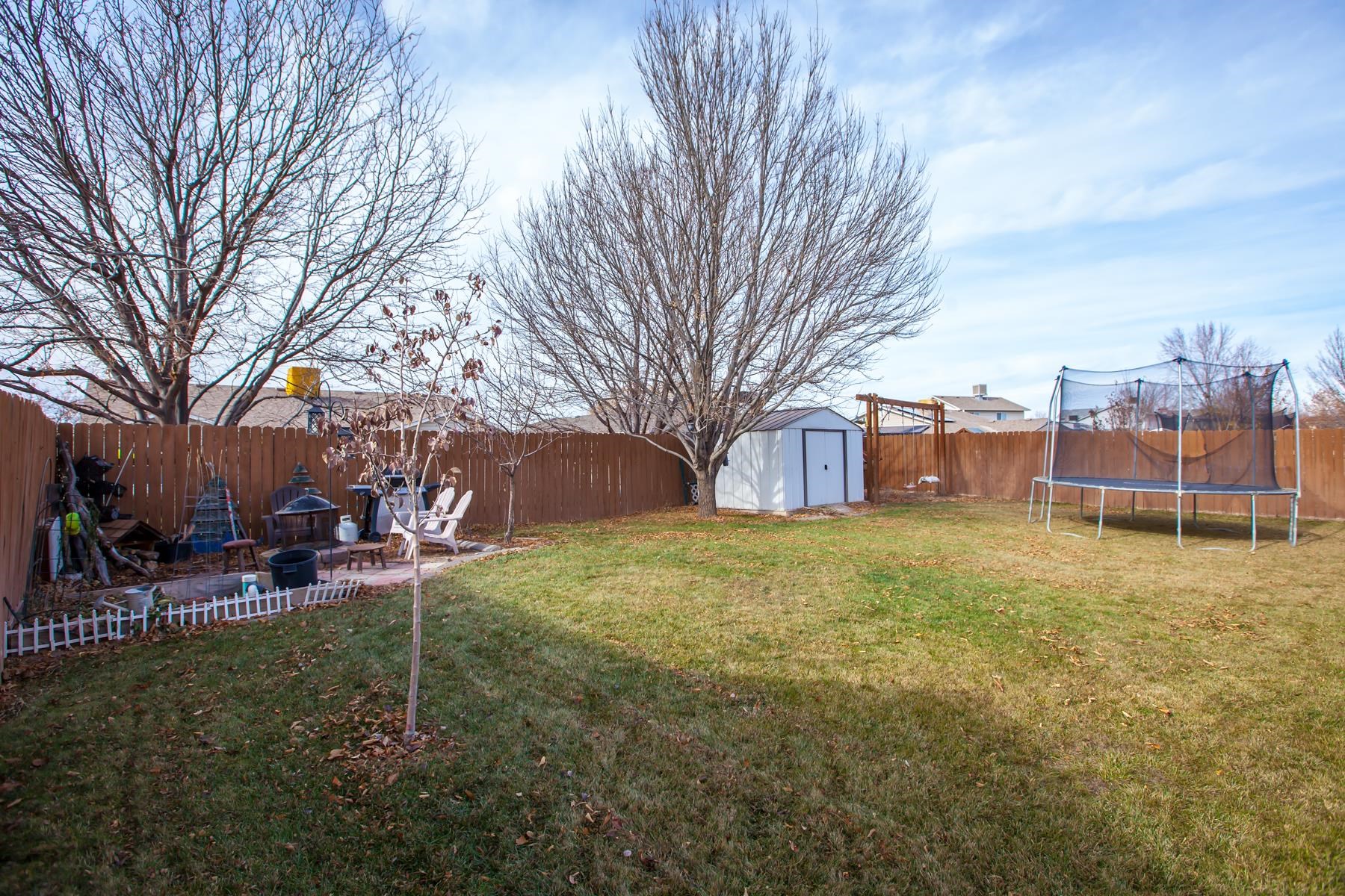 231 Narrow Leaf Drive Fruita, CO 81521 - Photo 33 of 40 a backyard of a house with table and chairs