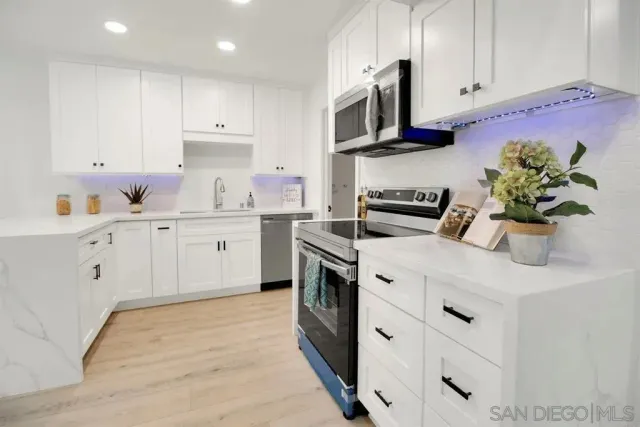 a kitchen with a sink stove and cabinets