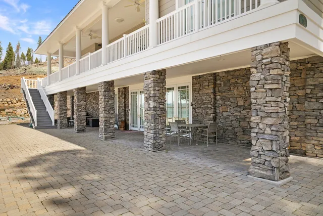 a balcony with table and chairs