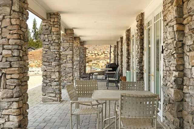 a living room with fireplace furniture and a large window