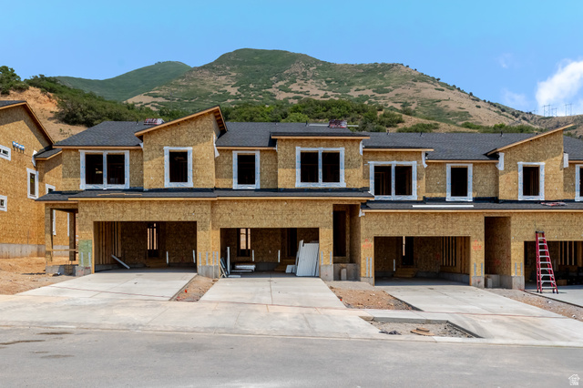 5387 South Acacia Drive, Unit 731 Mapleton, UT 84664 - Photo 1 of 5 New construction townhomes featuring asphalt shingle roofs and concrete driveways, set against a mountain backdrop
