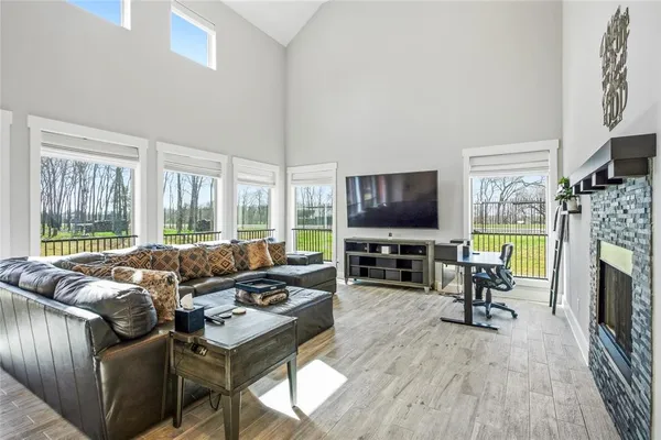 a living room with furniture a flat screen tv and a fireplace