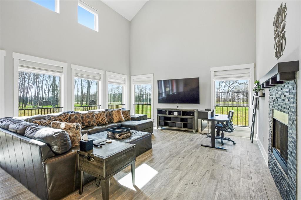 216 Glen Ellen Road Pottsboro, TX 75076 - Photo 11 of 38 a living room with furniture a flat screen tv and a fireplace