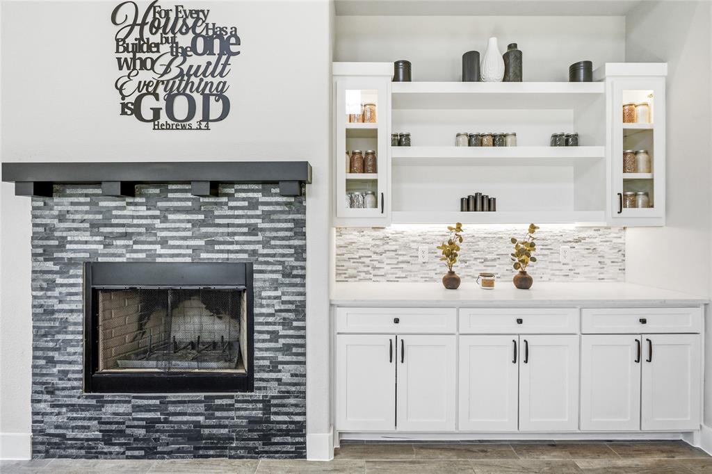216 Glen Ellen Road Pottsboro, TX 75076 - Photo 13 of 38 a living room with white cabinets and a fireplace