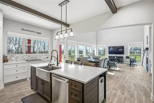 a open kitchen with stainless steel appliances granite countertop a stove and a view of living room