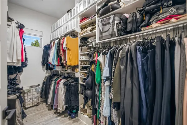 a view of walk in closet with clothes