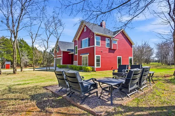 a view of a house with backyard and sitting area