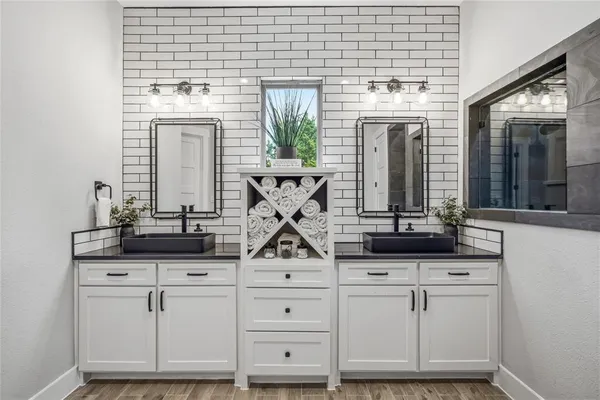 a view of kitchen with cabinets and window