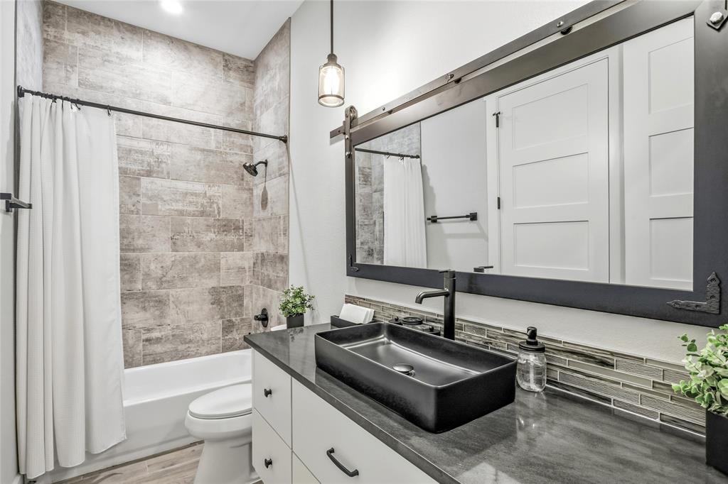 216 Glen Ellen Road Pottsboro, TX 75076 - Photo 24 of 38 a bathroom with a sink a toilet and shower