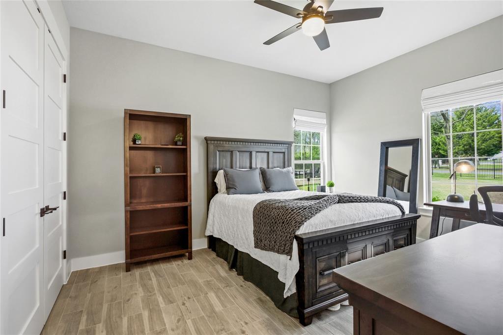 216 Glen Ellen Road Pottsboro, TX 75076 - Photo 26 of 38 a large bed sitting in a bedroom next to a window and a chandelier