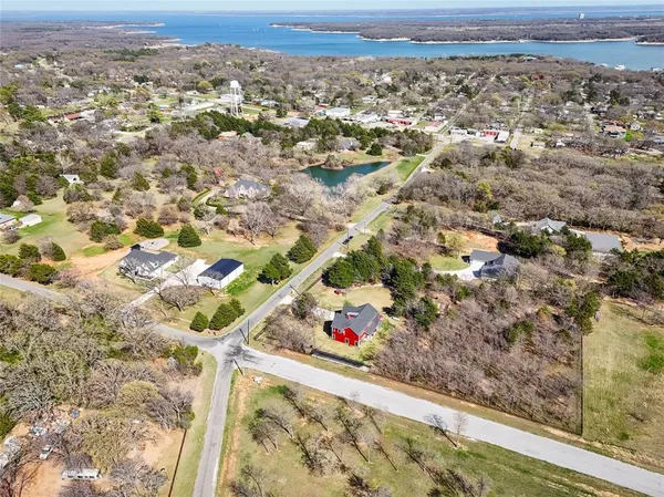 an aerial view of a residential houses with city view