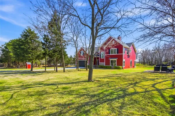 a view of a house with a yard and tree s