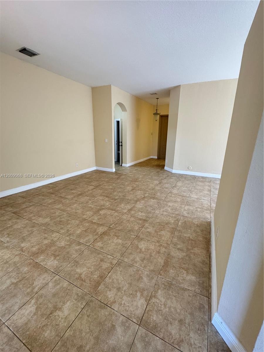 12860 Southwest 51st Street Miramar, FL 33027 - Photo 16 of 29 a view of an empty room and window