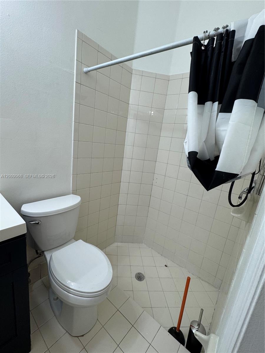 12860 Southwest 51st Street Miramar, FL 33027 - Photo 17 of 29 a white toilet sitting next to a bathroom sink