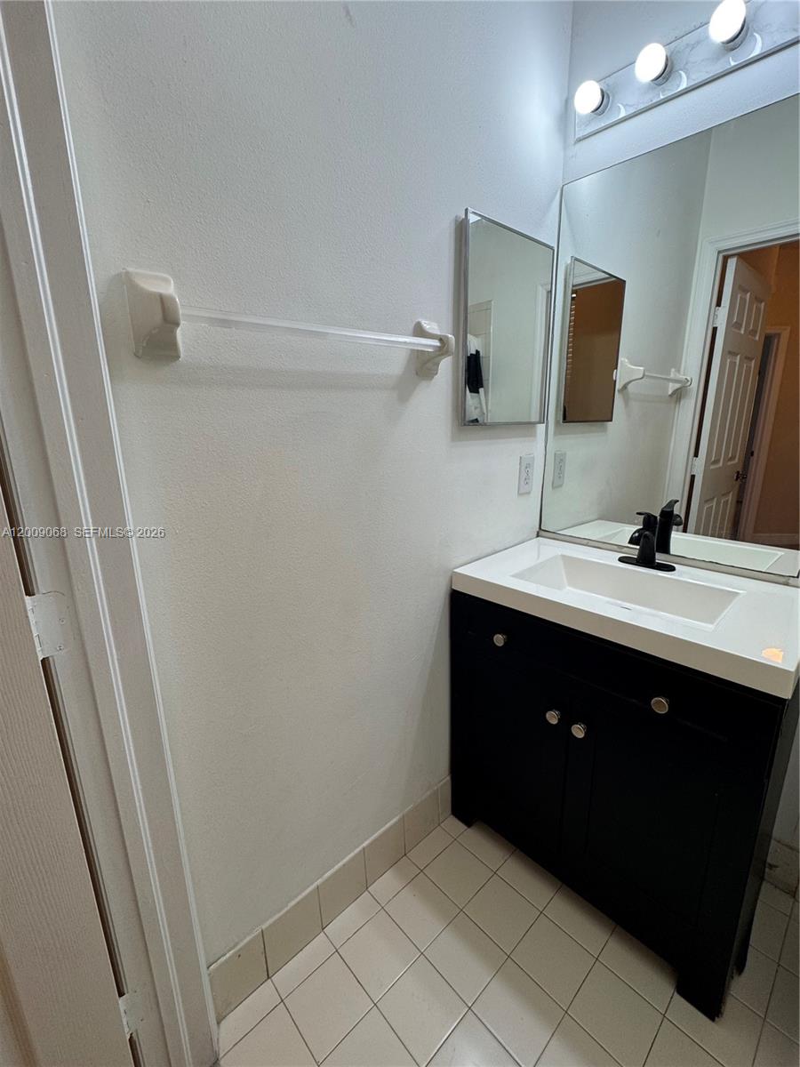 12860 Southwest 51st Street Miramar, FL 33027 - Photo 18 of 29 a bathroom with a sink vanity and mirror