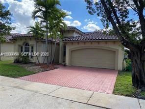 12860 Southwest 51st Street Miramar, FL 33027 - Photo 2 of 29 a front view of a house with patio