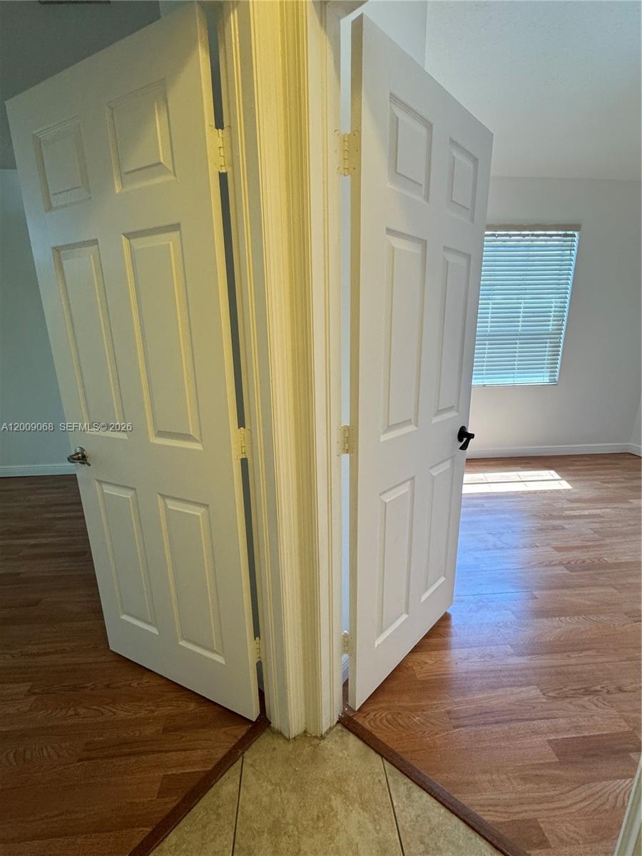 12860 Southwest 51st Street Miramar, FL 33027 - Photo 21 of 29 a view of a hallway with wooden floor