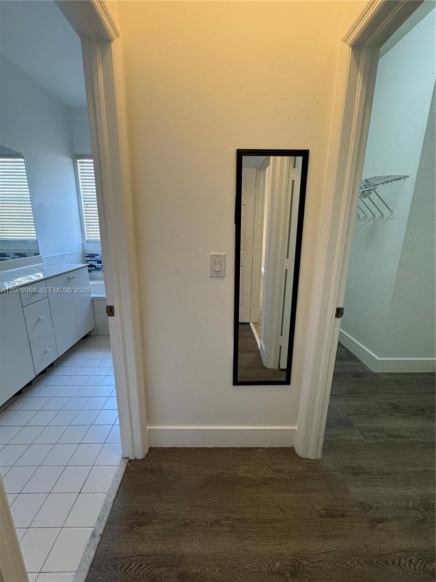 12860 Southwest 51st Street Miramar, FL 33027 - Photo 24 of 29 a view of an empty room with wooden floor and a window