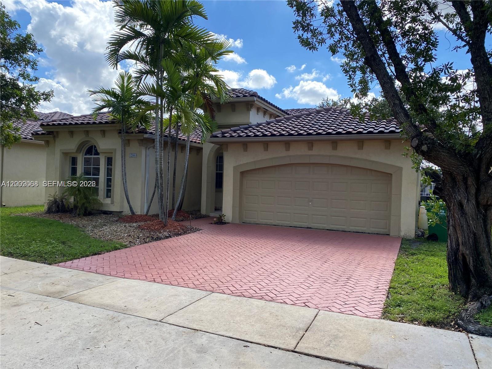 12860 Southwest 51st Street Miramar, FL 33027 - Photo 29 of 29 a view of a house with a garage