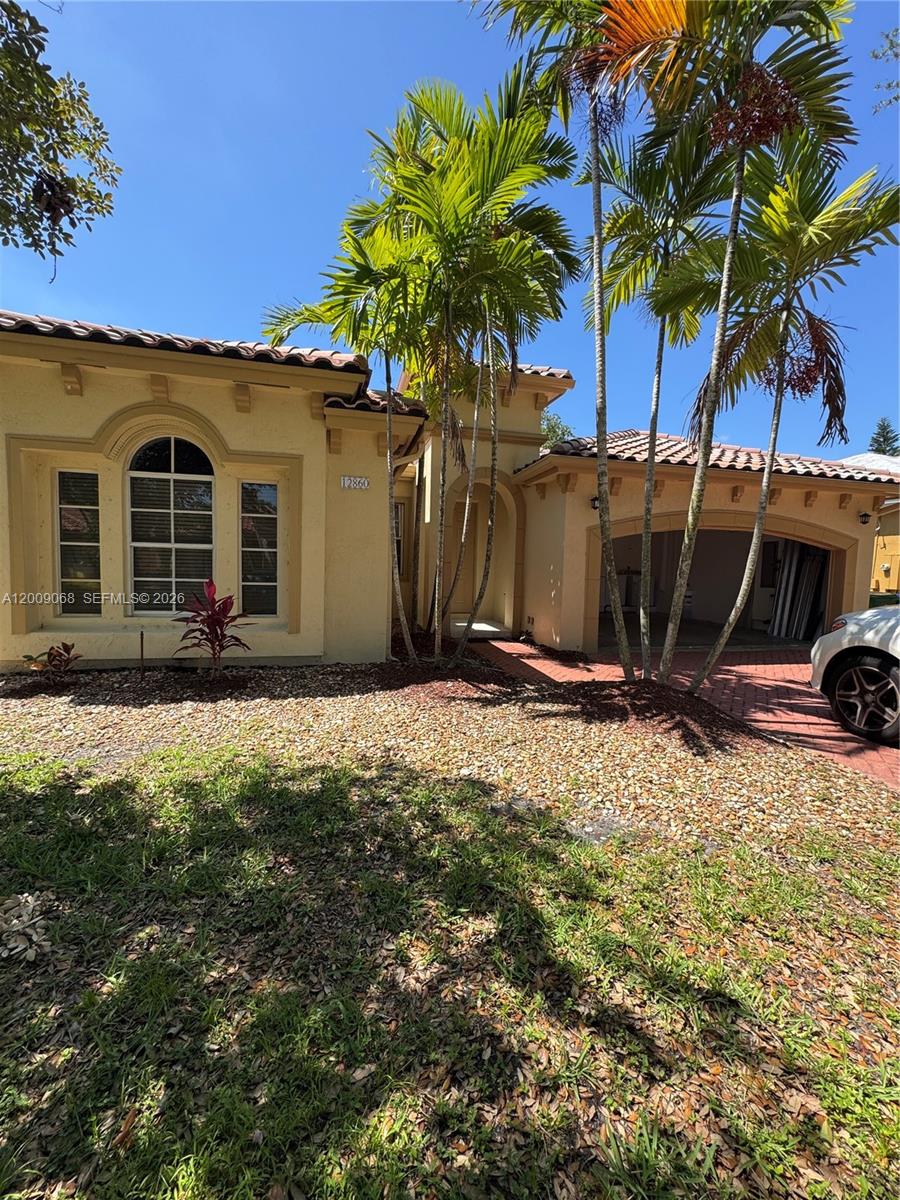 12860 Southwest 51st Street Miramar, FL 33027 - Photo 4 of 29 a view of a house with a yard