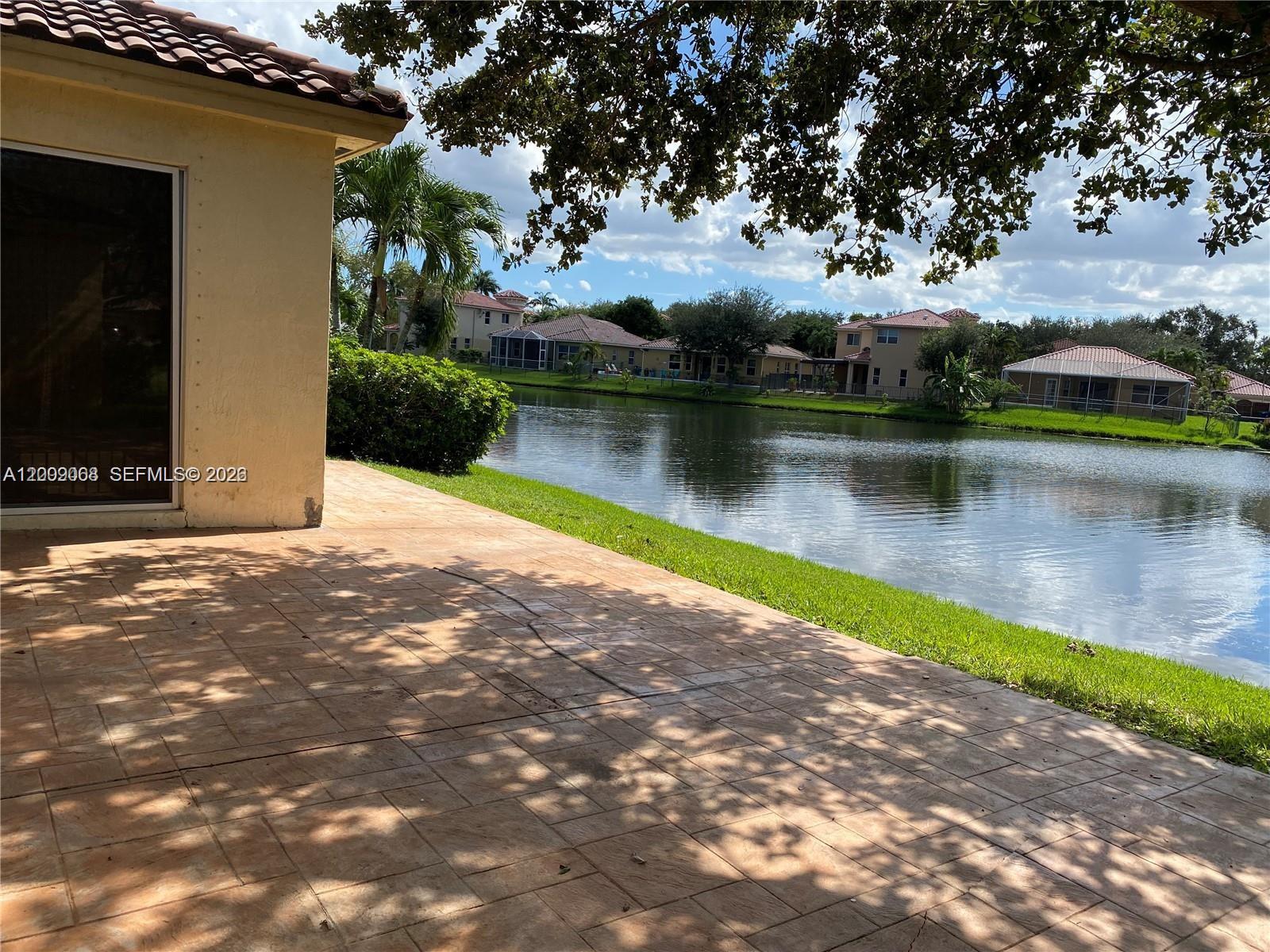 12860 Southwest 51st Street Miramar, FL 33027 - Photo 6 of 29 a view of a lake with houses
