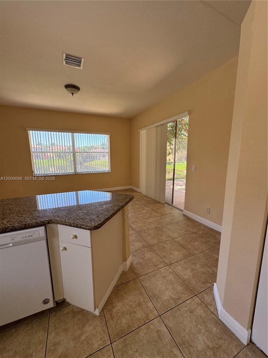 12860 Southwest 51st Street Miramar, FL 33027 - Photo 8 of 29 an empty room with windows