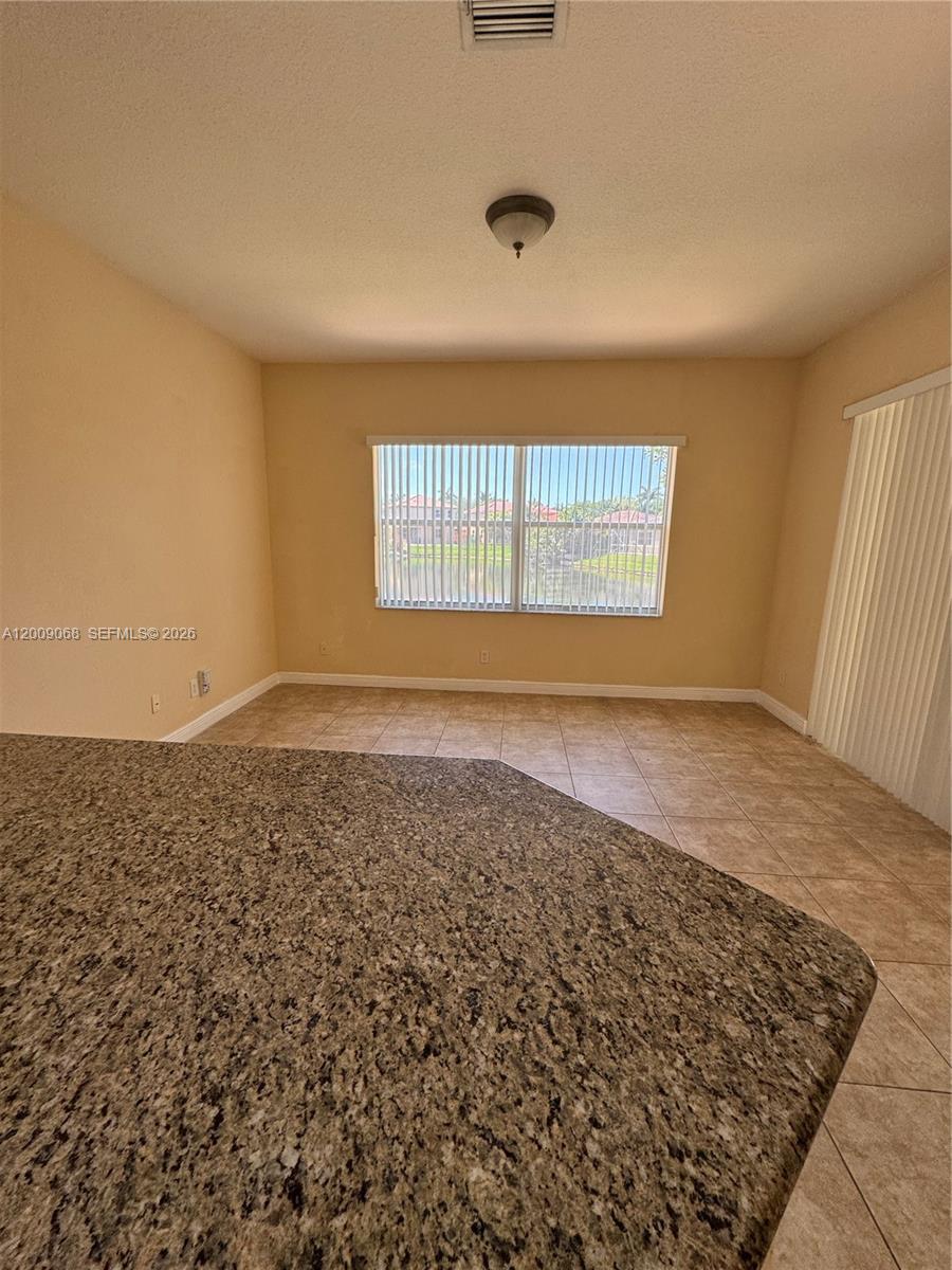 12860 Southwest 51st Street Miramar, FL 33027 - Photo 10 of 29 an empty room with a window