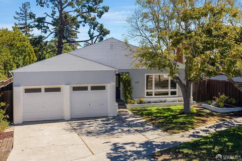 a house that has a tree in front of it