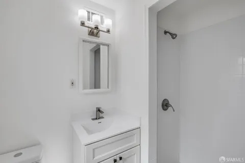 a bathroom with a sink mirror and vanity