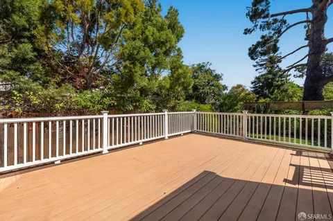 a view of balcony with wooden floor and fence