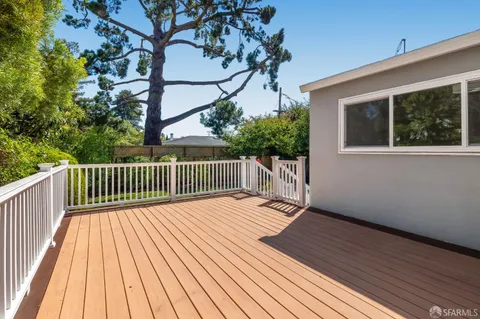 a balcony with wooden floor and fence