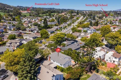an aerial view of residential houses with outdoor space and swimming pool