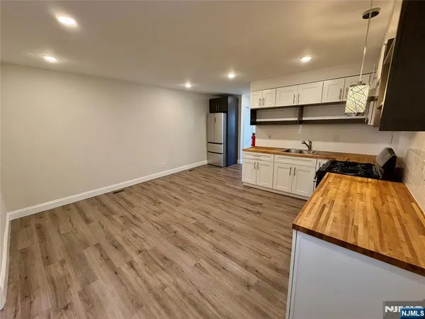 a view of kitchen with wooden floor and electronic appliances