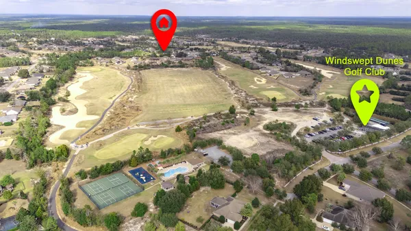 an aerial view of residential houses with outdoor space and swimming pool