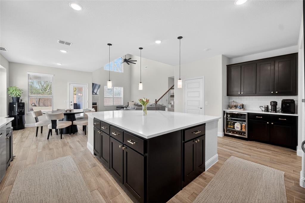 596 Randys Way Pilot Point, TX 76258 - Photo 11 of 40 a kitchen with counter top space a sink a stove a refrigerator cabinets and a kitchen island
