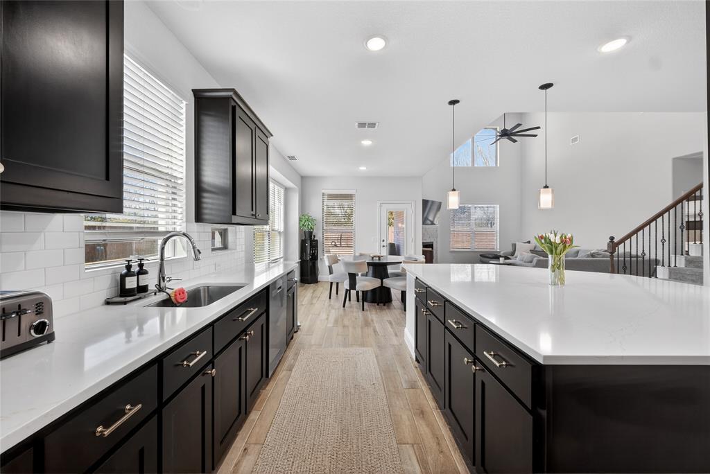 596 Randys Way Pilot Point, TX 76258 - Photo 12 of 40 a kitchen with sink a stove and cabinets