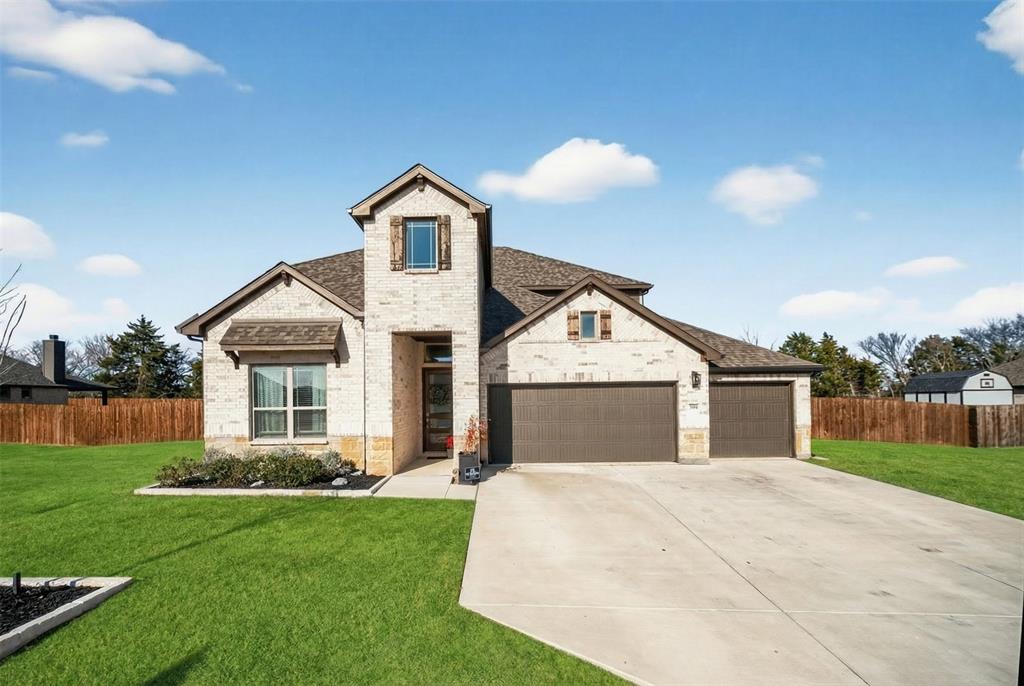 596 Randys Way Pilot Point, TX 76258 - Photo 2 of 40 a front view of a house with garden