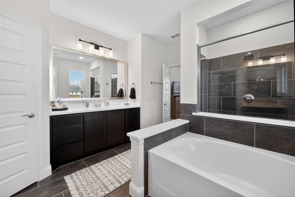 596 Randys Way Pilot Point, TX 76258 - Photo 23 of 40 a spacious bathroom with a tub sink and mirror