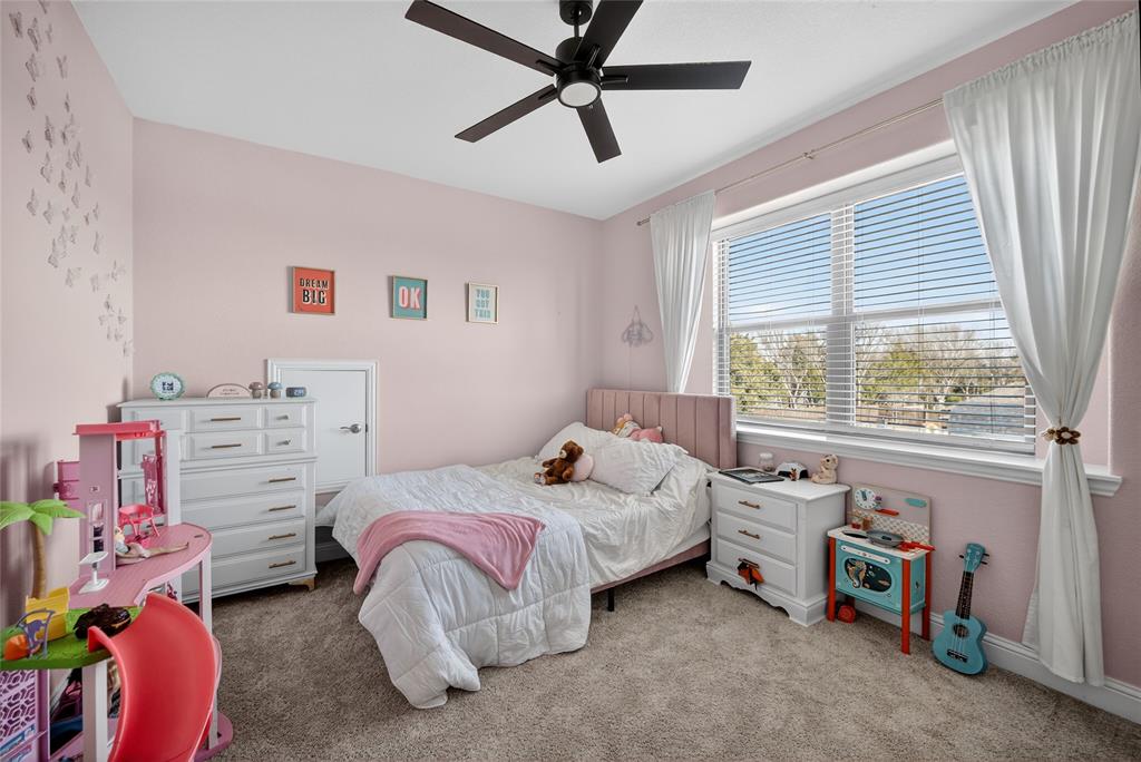 596 Randys Way Pilot Point, TX 76258 - Photo 30 of 40 a bedroom with a bed and a window