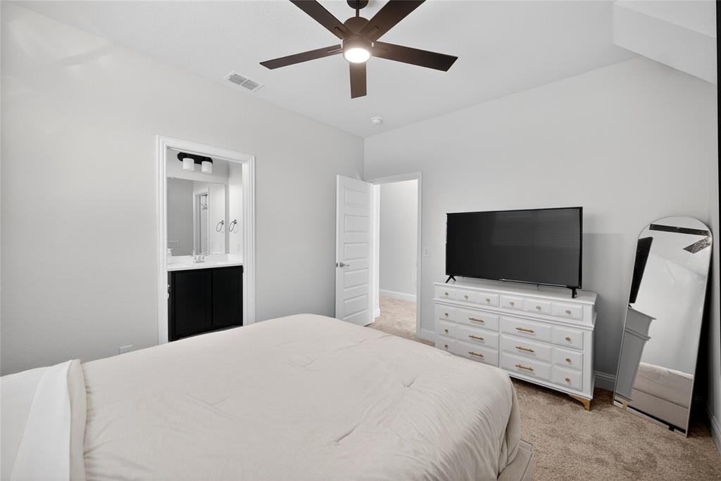596 Randys Way Pilot Point, TX 76258 - Photo 32 of 40 a bedroom with a bed and a flat screen tv