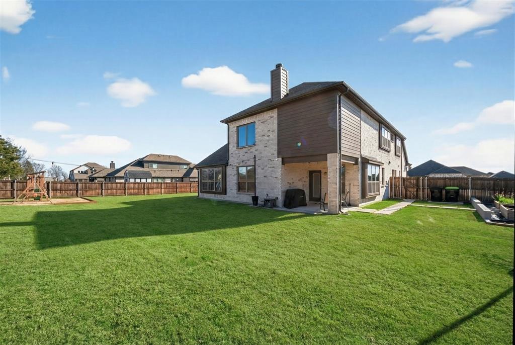 596 Randys Way Pilot Point, TX 76258 - Photo 37 of 40 a view of a big house with a big yard and large trees
