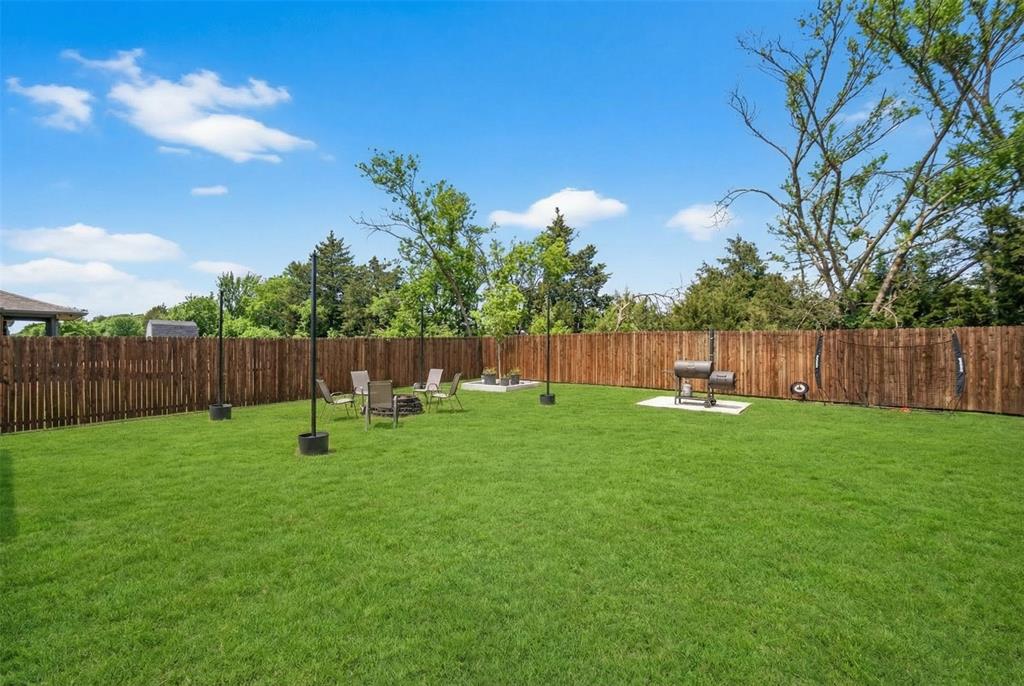 596 Randys Way Pilot Point, TX 76258 - Photo 39 of 40 a view of a backyard with a garden and entertaining space