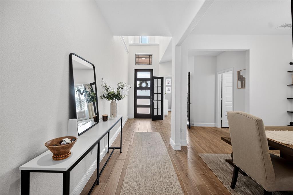 596 Randys Way Pilot Point, TX 76258 - Photo 8 of 40 a view of a hallway to room with wooden floor and furniture