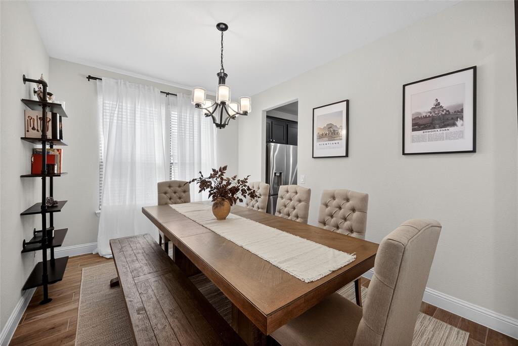 596 Randys Way Pilot Point, TX 76258 - Photo 9 of 40 a view of a dining room with furniture and wooden floor
