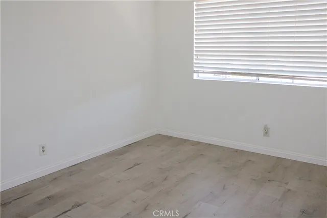 a potted plant sitting in front of a door with wooden fence