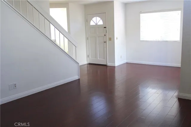 a kitchen with white cabinets and appliances
