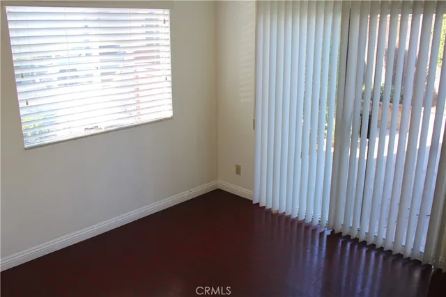 a kitchen with white cabinets and appliances