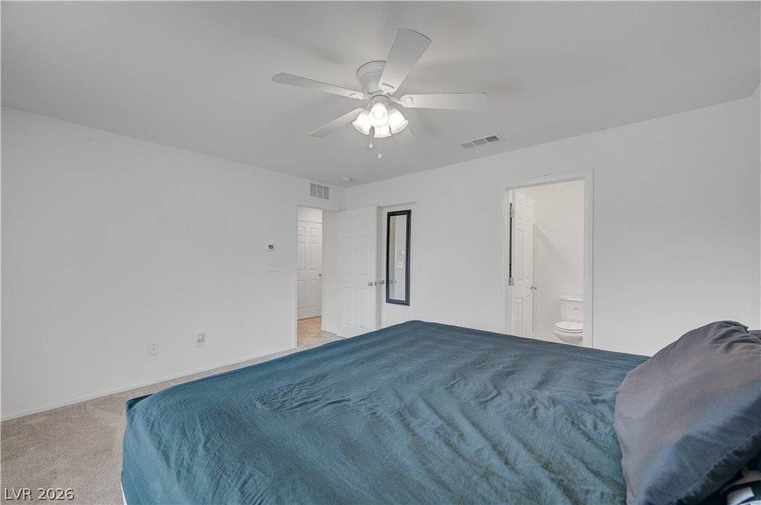 1287 Raritan Place Henderson, NV 89002 - Photo 5 of 21 A comfortable bedroom with soft carpeting and convenient access to an en-suite bath and closet.