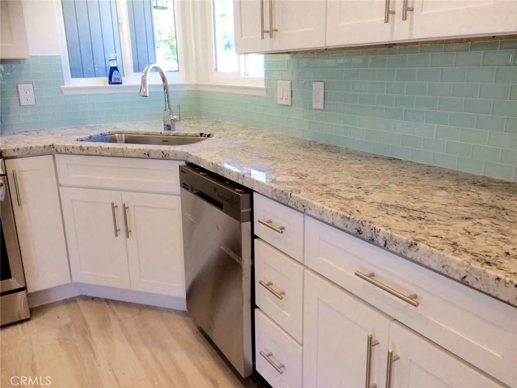 34095 Aurelio Dana Point, CA 92629 - Photo 12 of 32 a kitchen with granite countertop a sink a stove and cabinets